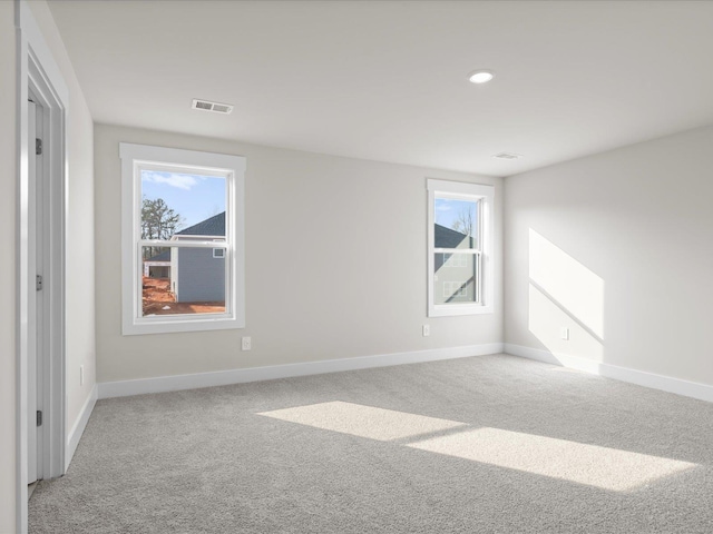 unfurnished room with light colored carpet