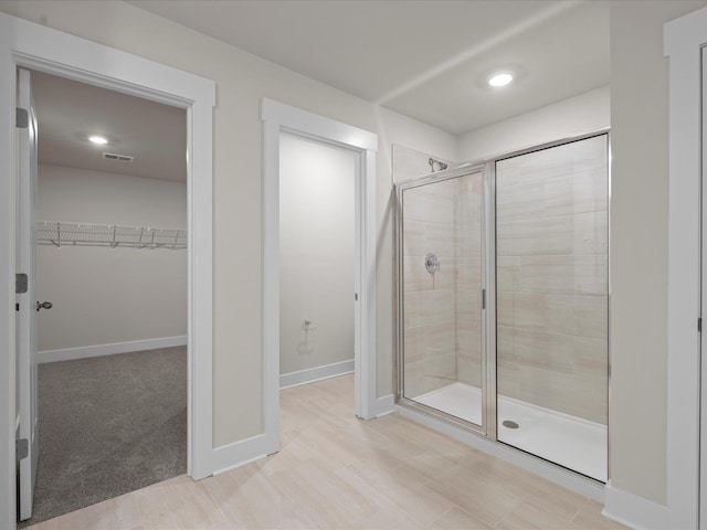 bathroom featuring a shower with shower door