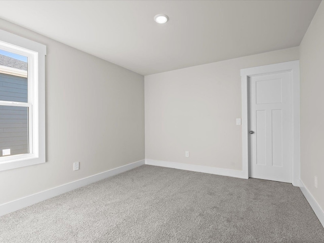 carpeted spare room with a healthy amount of sunlight