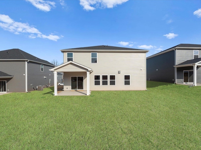 rear view of property featuring a yard, central air condition unit, and a patio area