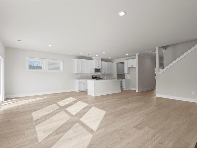 unfurnished living room with light hardwood / wood-style floors