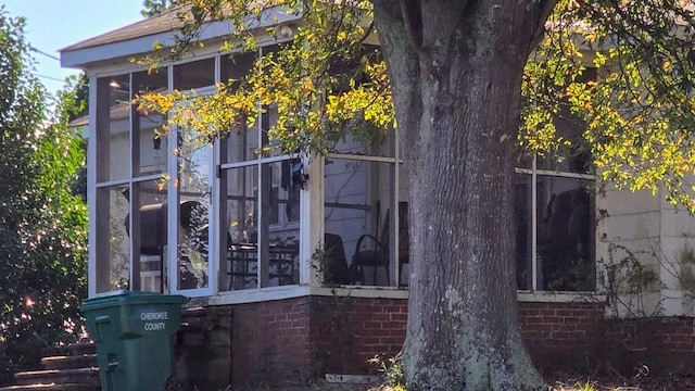 view of property exterior featuring a sunroom