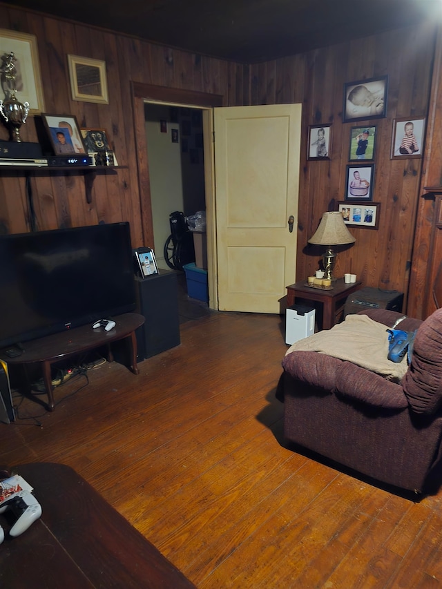 living room with wood walls and dark hardwood / wood-style flooring