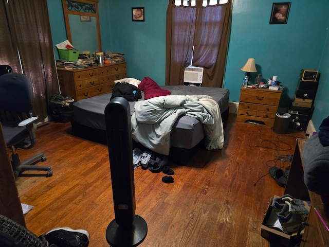 bedroom with wood-type flooring and cooling unit