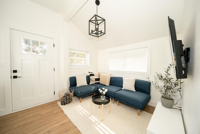 interior space featuring wood-type flooring, an inviting chandelier, and lofted ceiling