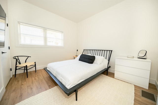 bedroom with wood-type flooring