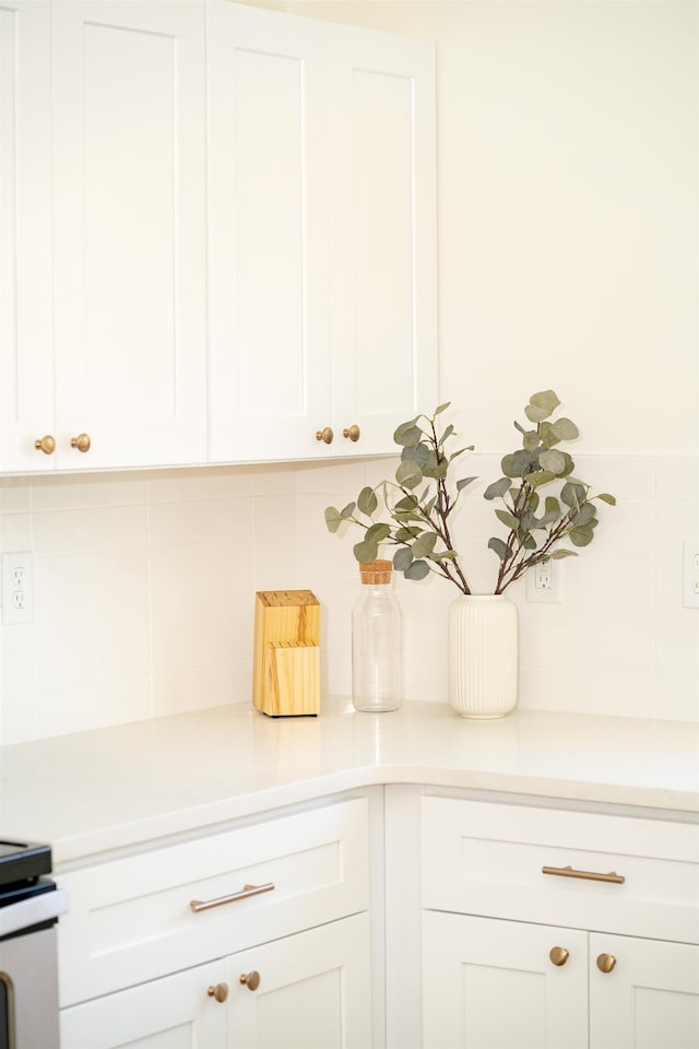 kitchen featuring white cabinetry and backsplash