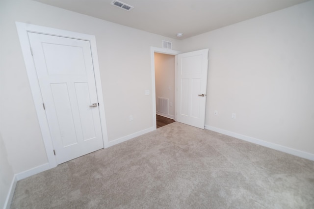 unfurnished bedroom with a closet and carpet flooring