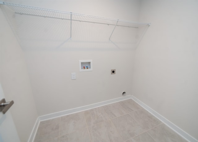 laundry room with hookup for an electric dryer, hookup for a washing machine, and light tile patterned floors