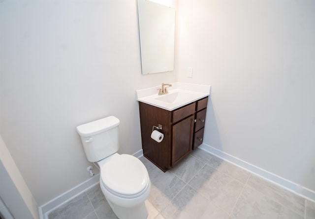 bathroom with vanity, tile patterned floors, and toilet