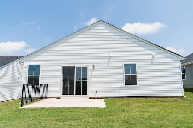 back of house with a yard and a patio area