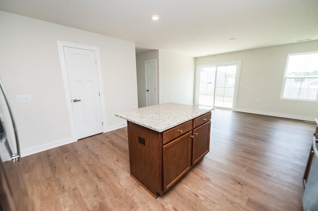 kitchen with light wood-type flooring and a center island