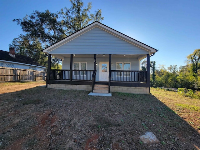 bungalow-style house with a porch and a front lawn