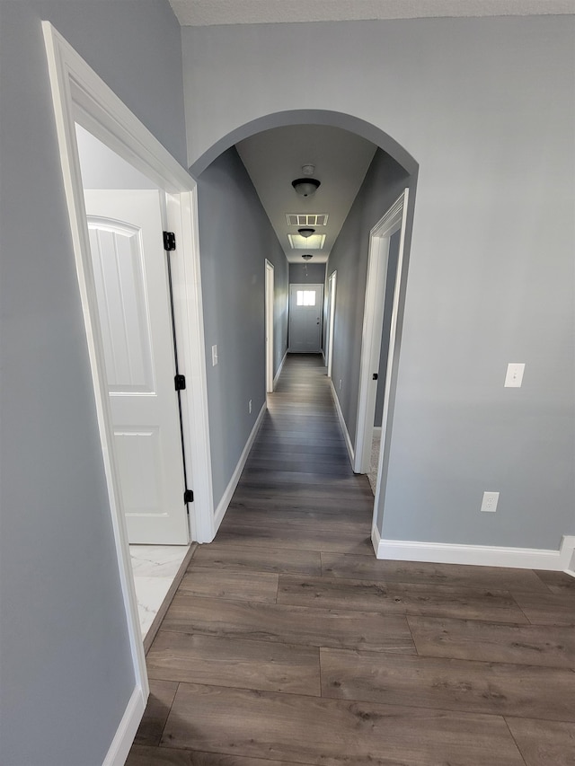 corridor featuring dark hardwood / wood-style flooring