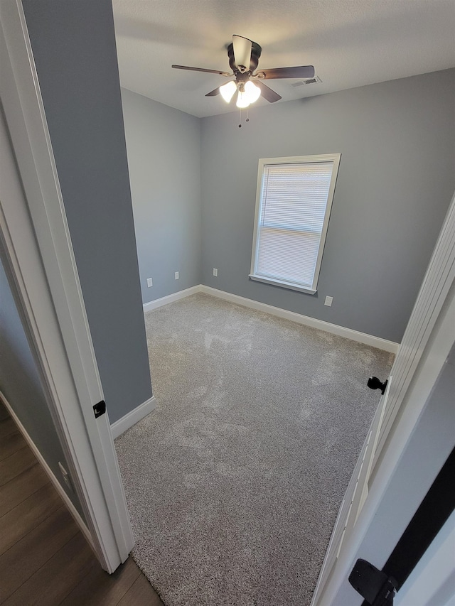 carpeted empty room with ceiling fan