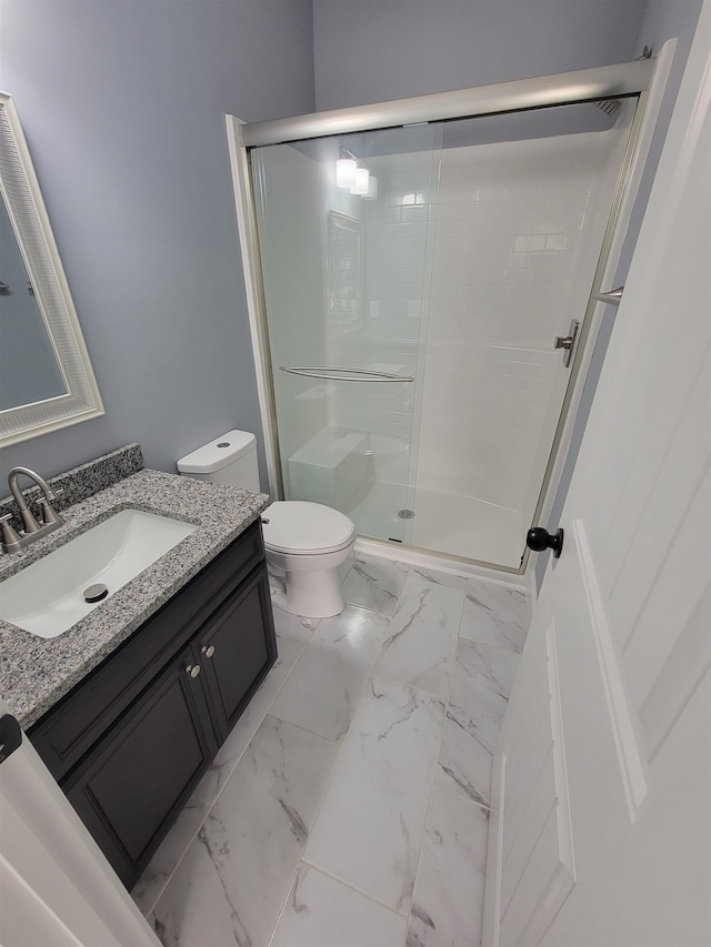 bathroom featuring walk in shower, vanity, and toilet