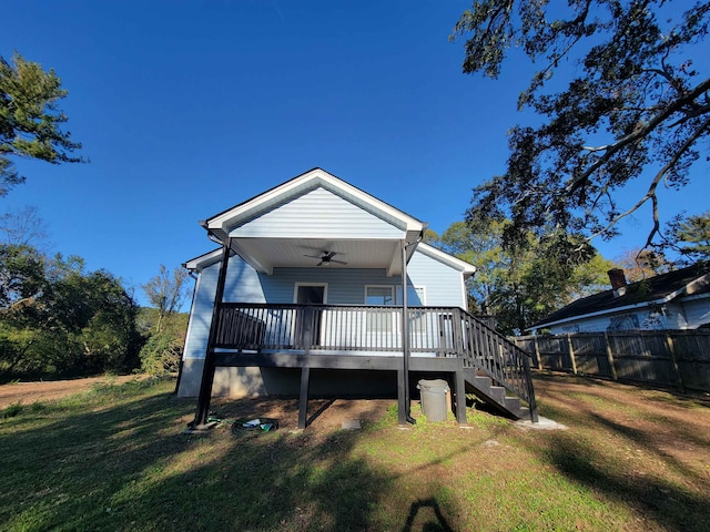 back of property featuring a yard, ceiling fan, and a wooden deck