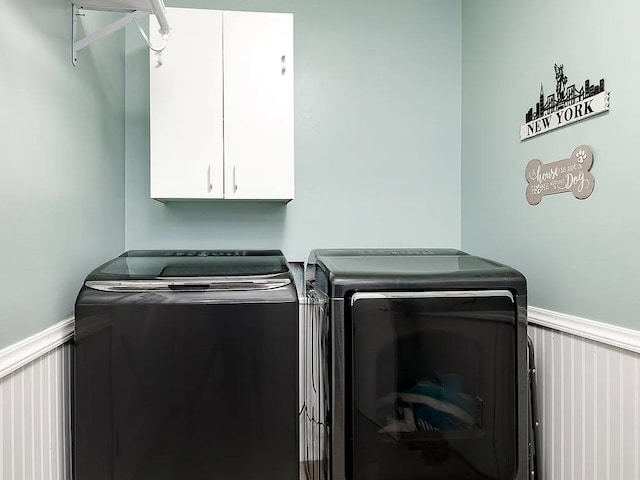 laundry area featuring cabinets and washing machine and clothes dryer