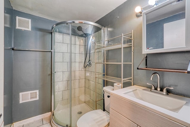 bathroom featuring vanity, toilet, tile patterned floors, and a shower with door