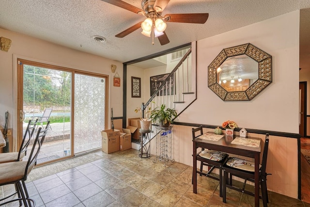 dining area featuring a textured ceiling and ceiling fan