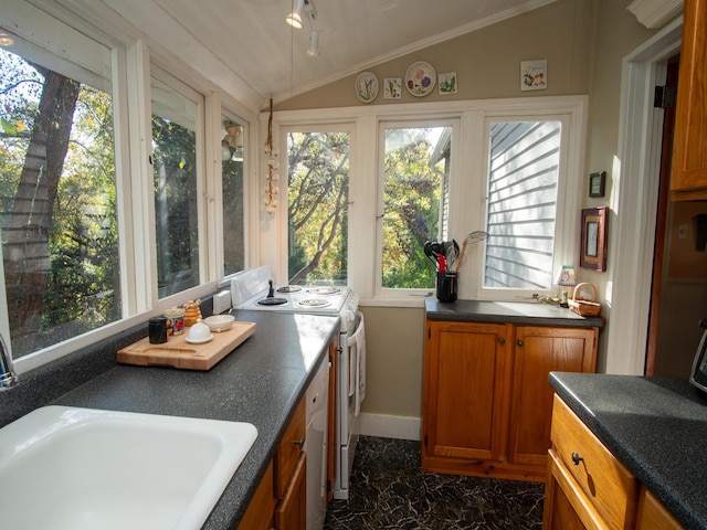 sunroom featuring vaulted ceiling and sink