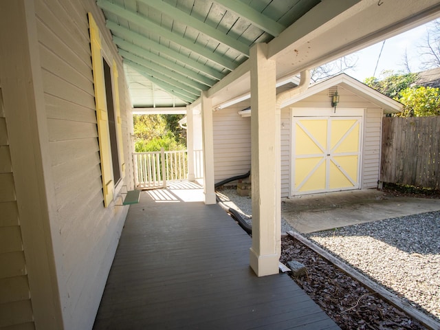 exterior space with covered porch and a storage shed