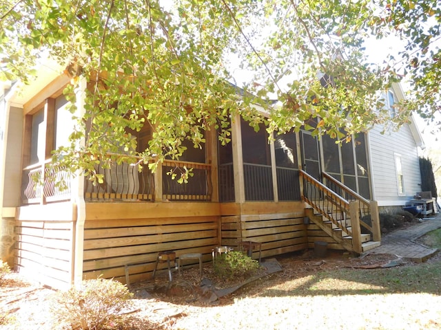 rear view of property with a sunroom