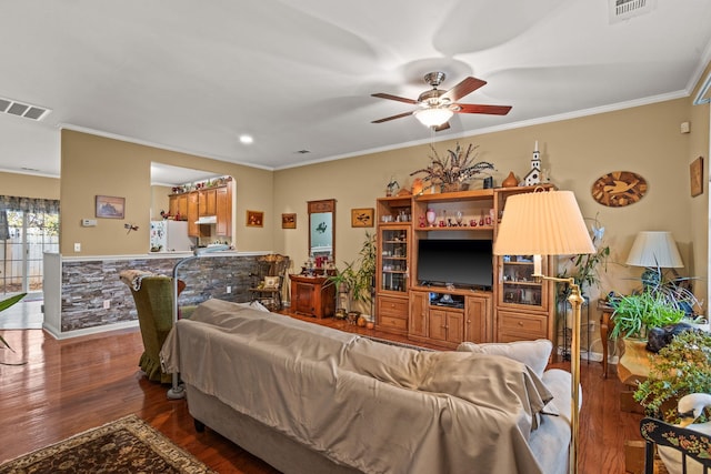 living room with ceiling fan, crown molding, and dark hardwood / wood-style floors