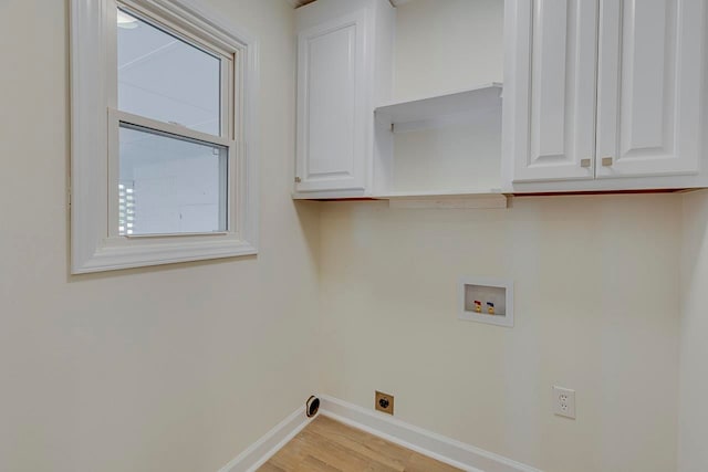 laundry area with electric dryer hookup, cabinets, washer hookup, and light wood-type flooring