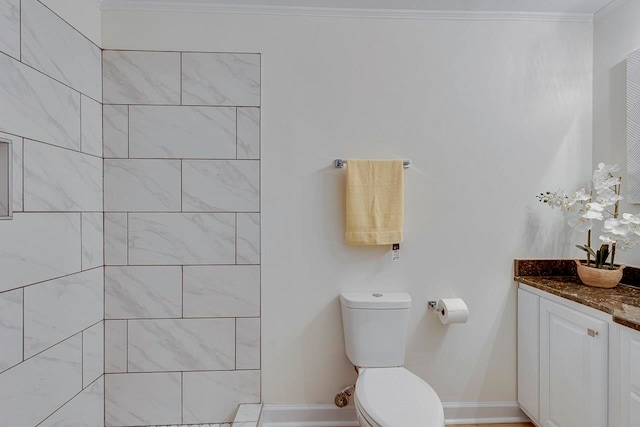 bathroom featuring vanity, toilet, and crown molding