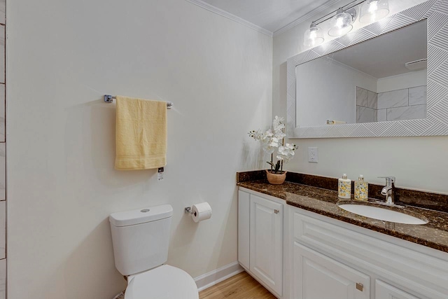 bathroom with vanity, hardwood / wood-style flooring, toilet, and crown molding