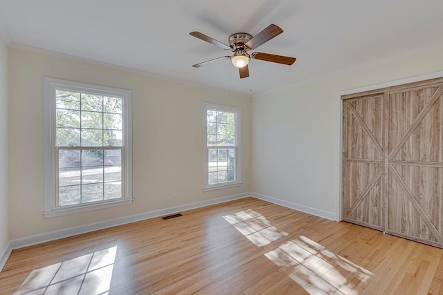 unfurnished bedroom with ceiling fan, light hardwood / wood-style floors, and crown molding