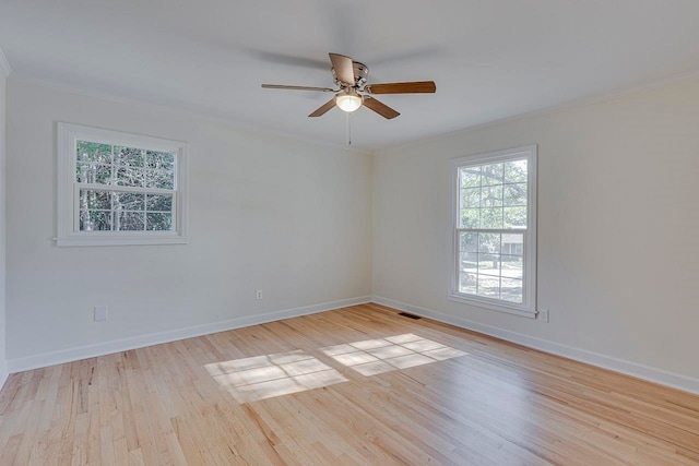 empty room featuring ceiling fan, light hardwood / wood-style floors, and crown molding