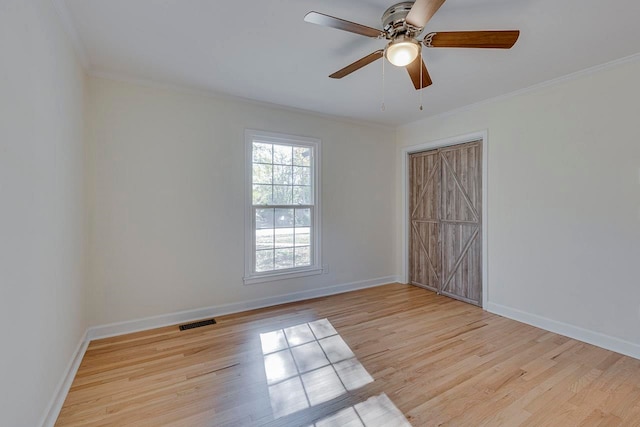 spare room with light hardwood / wood-style flooring, ceiling fan, and ornamental molding