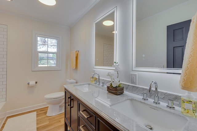 bathroom with vanity, toilet, wood-type flooring, and ornamental molding