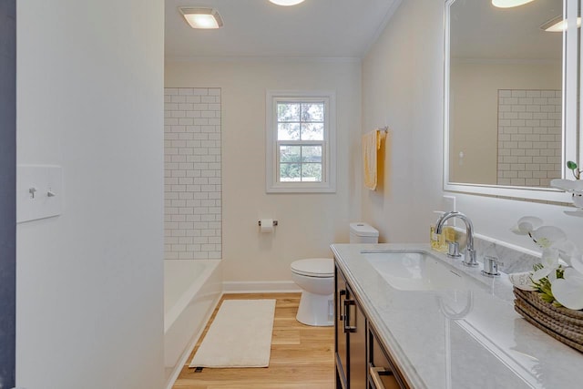 bathroom featuring vanity, hardwood / wood-style flooring, toilet, and crown molding