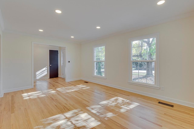 unfurnished room featuring light hardwood / wood-style flooring and crown molding