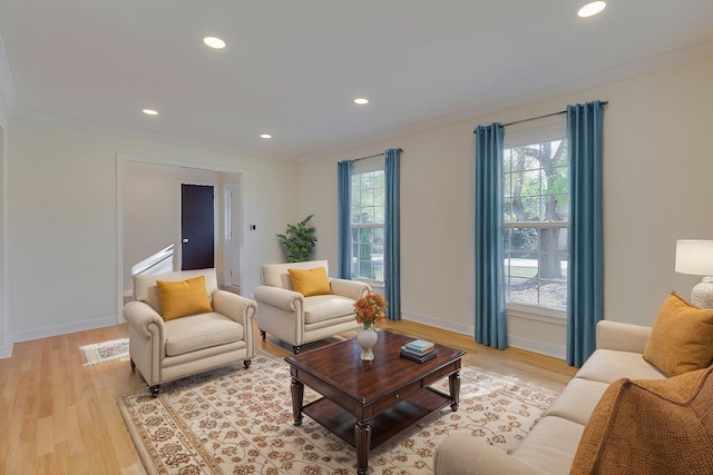 living room with light wood-type flooring and crown molding