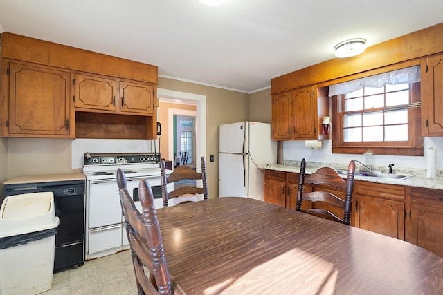 kitchen featuring sink, white appliances, crown molding, and light tile patterned floors