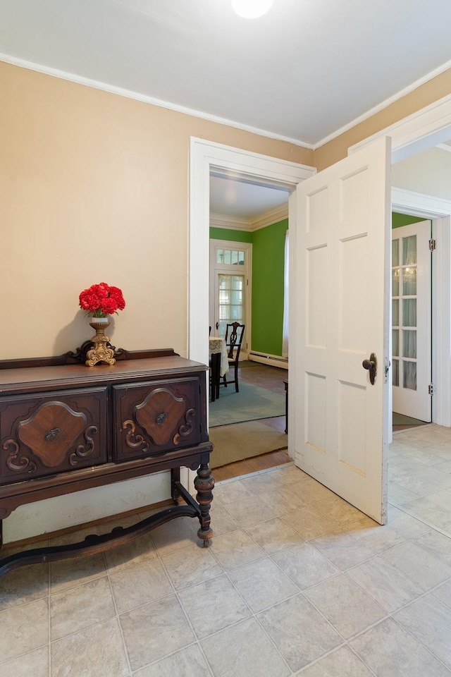 entryway featuring a baseboard radiator and ornamental molding