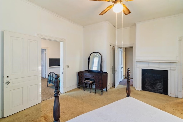 carpeted bedroom with ceiling fan and ornamental molding