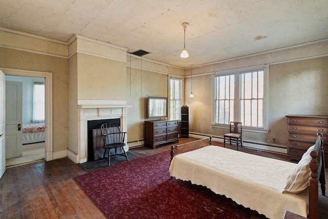 bedroom featuring baseboard heating and dark wood-type flooring