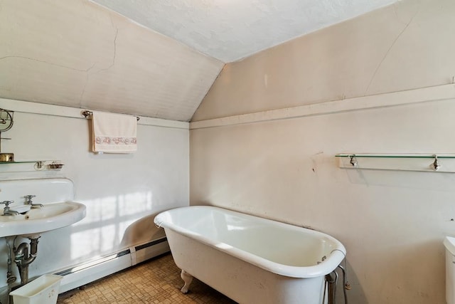 bathroom featuring sink, vaulted ceiling, a baseboard heating unit, and a tub