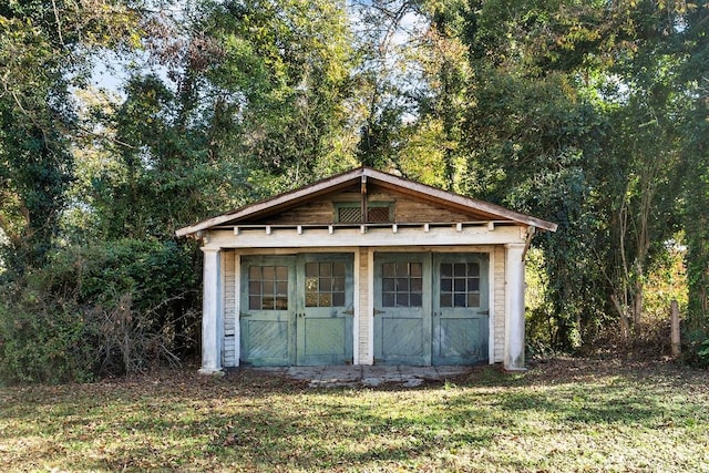 view of outdoor structure with a lawn