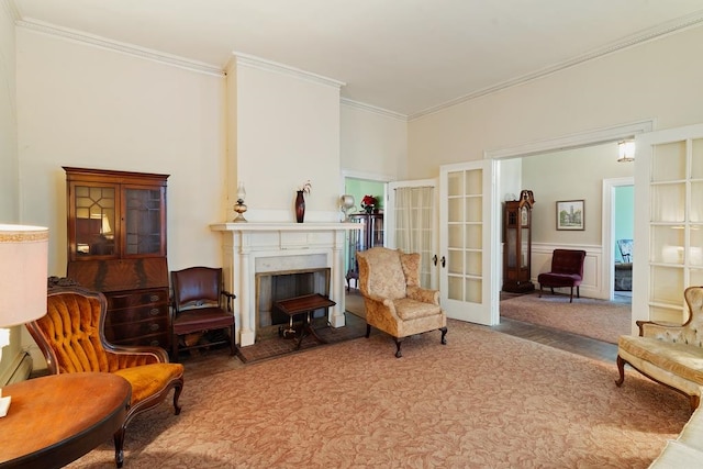 sitting room featuring carpet, french doors, and crown molding