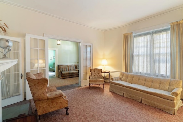 carpeted living room featuring a fireplace, crown molding, and french doors