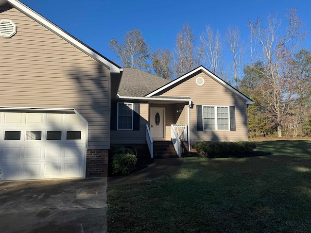 view of front of home with a garage and a front yard