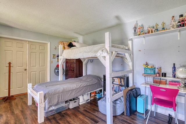 bedroom with a textured ceiling and wood finished floors