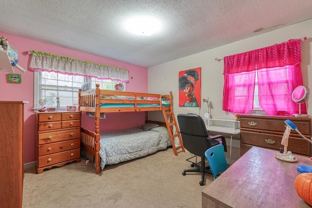 bedroom with a textured ceiling and carpet flooring