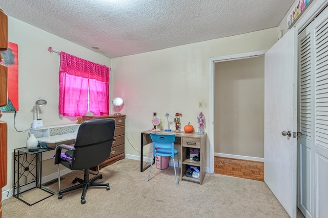 office area with a textured ceiling and baseboards